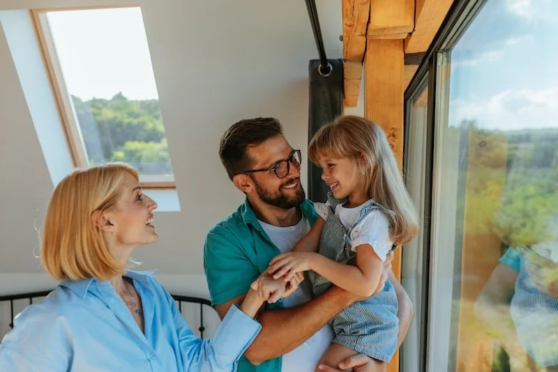 Family in front of new window upgrade supported by SEAI grants