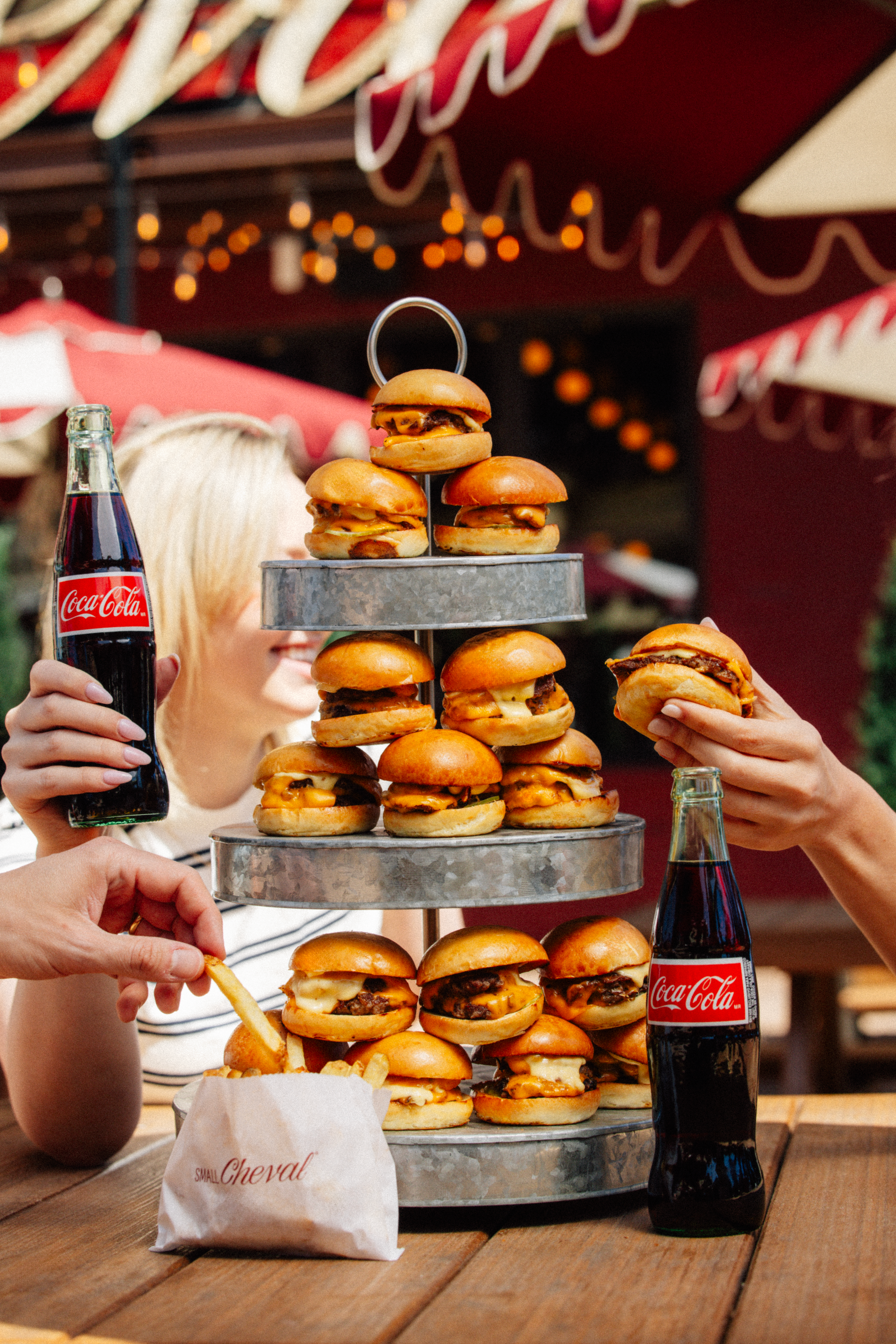 Group of hands reaching toward catering sliders