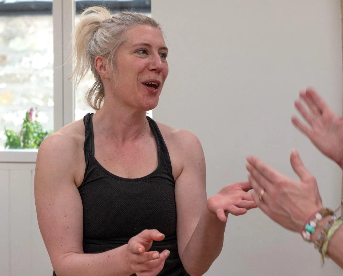 Women talking to another person in yoga space