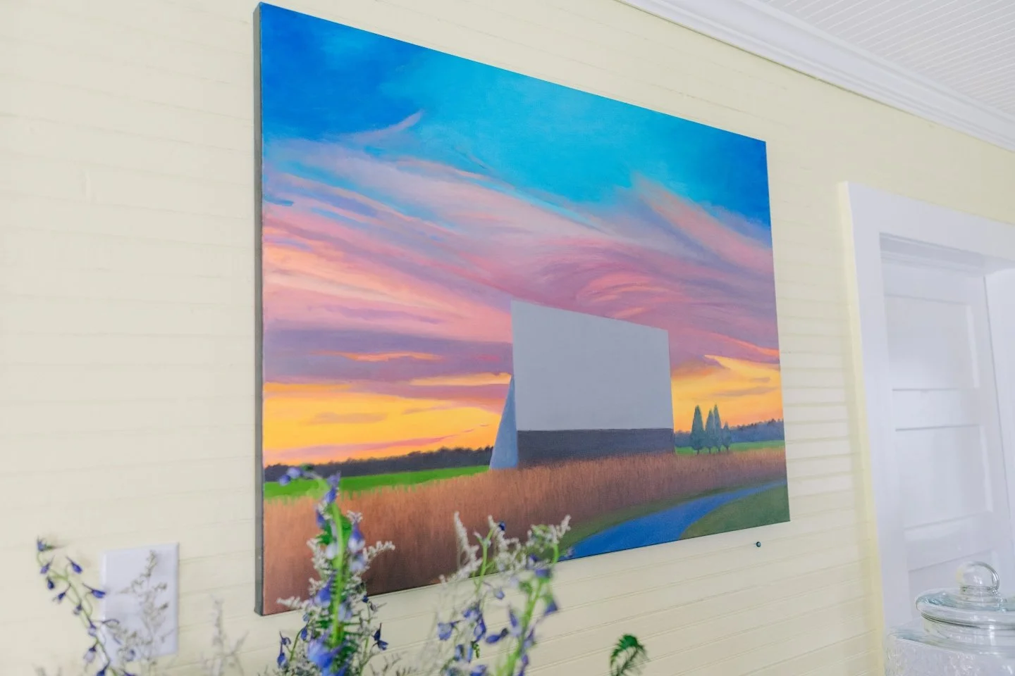 A brightly colored painting of a barn by artist David Davenport.