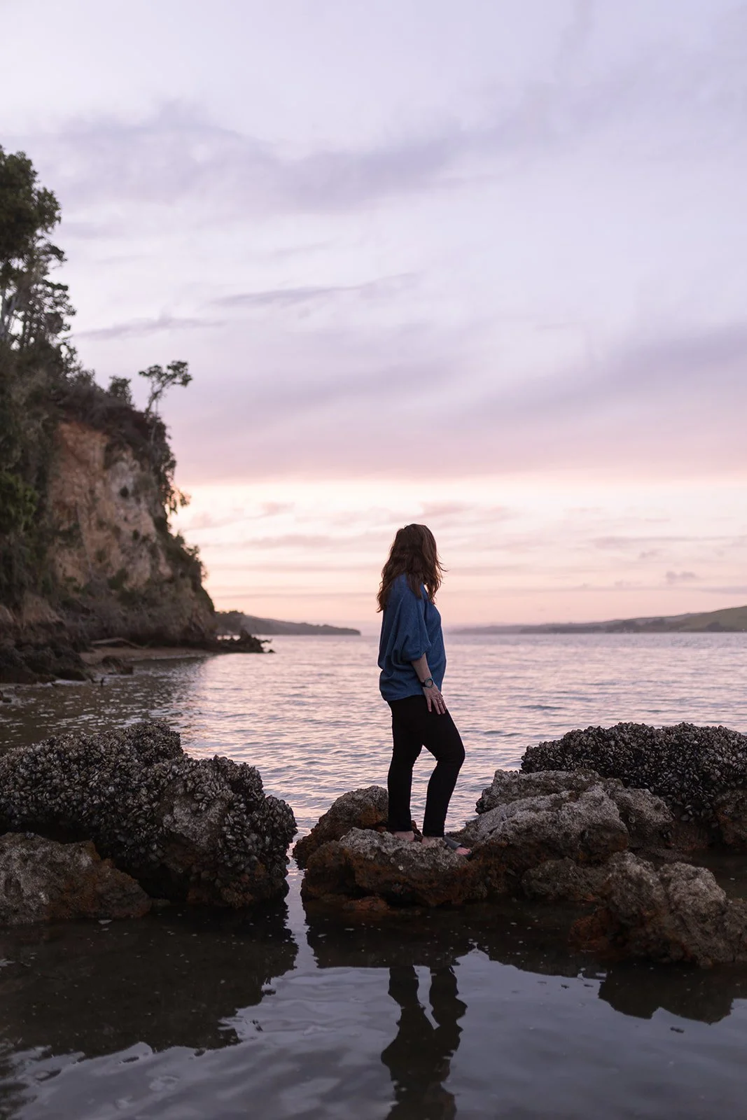 Michelle McAndrew Olsen  looking out over Tomales Bay at sunset.