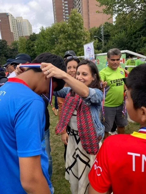 Handing out medals to the kids who participated in the Toronto Nepalese Soccer Club Tournament 2023 @ Detonia Park.  Team sports are so beneficial for self-esteem, fitness, team work and competition.