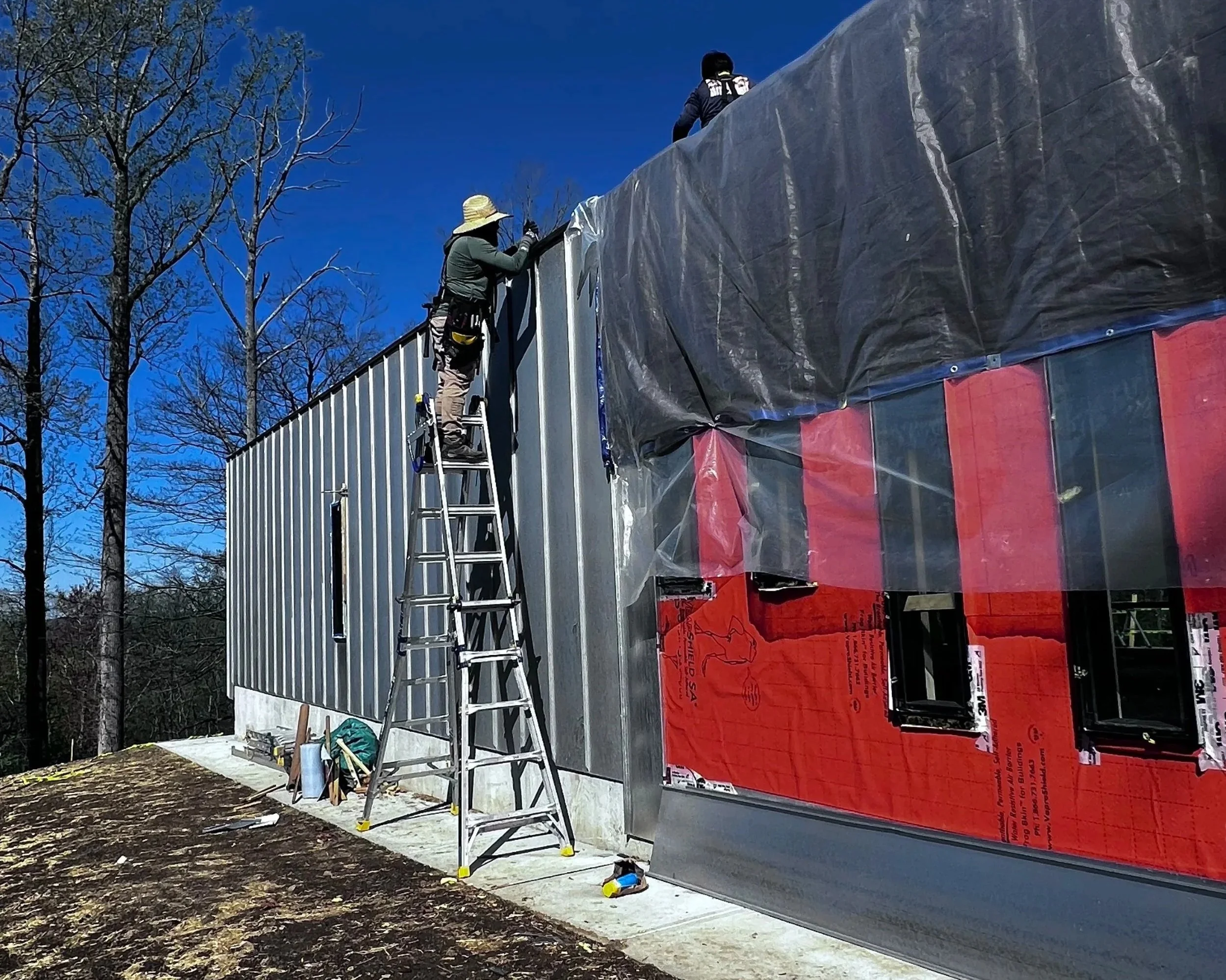 Workers on custom pool house designed for private residence.
