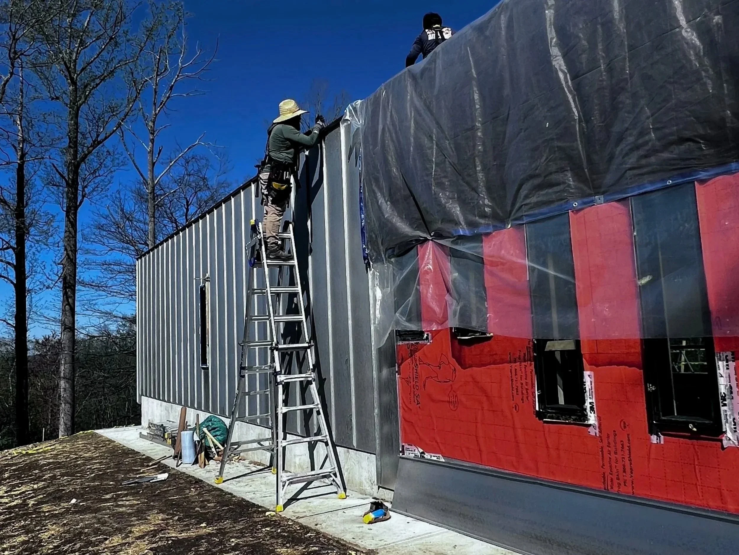 Workers on custom pool house designed for private residence.