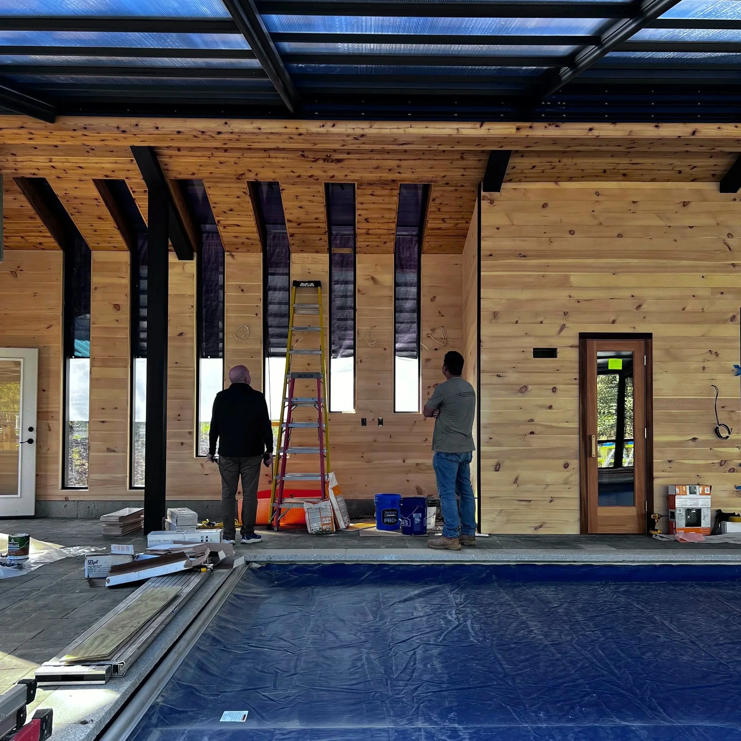 Looking on a skylight wall on a pool house construction with a contractor.  