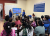 Adhikaar’s healthcare program staff giving a presentation on the NYC Care program to community members.