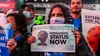 Adhikaar members holding signs at a TPS/Immigration rally at Times Square.