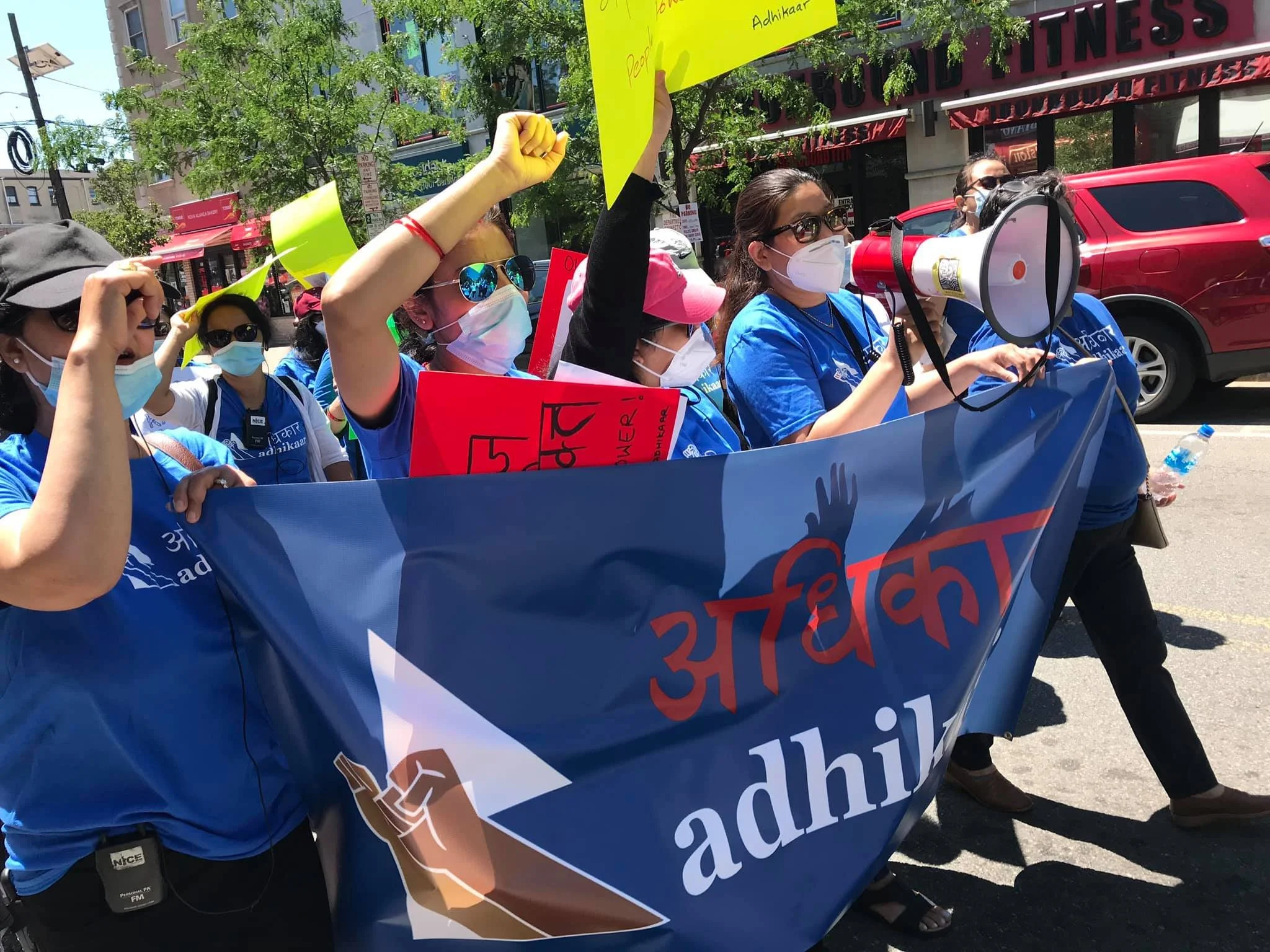 New Jersey Domestic Worker members holding an Adhikaar banner at a workers march to rally for the NJ Domestic Worker Bill of Rights.