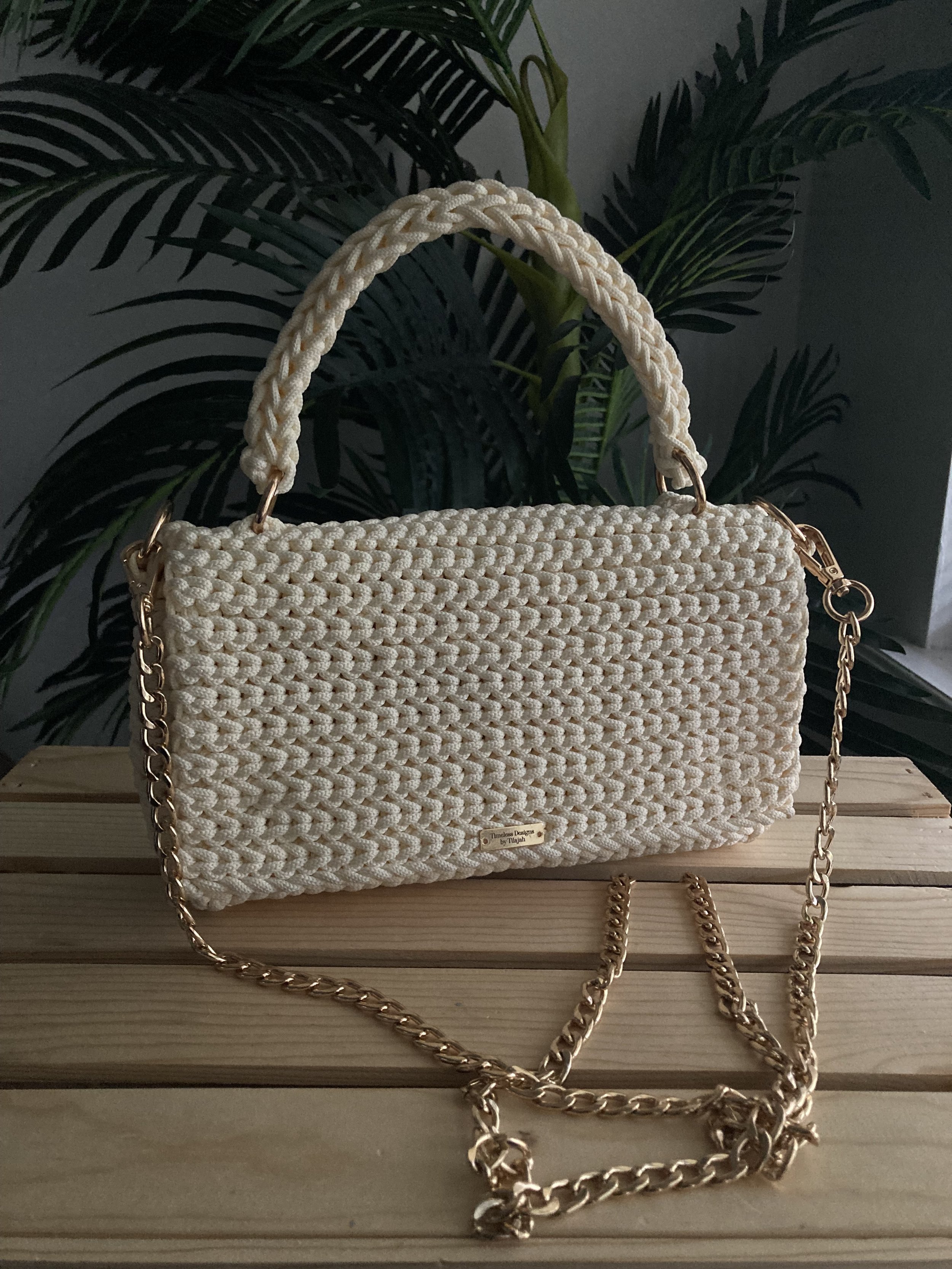 cream crochet clutch handbag with a crochet purse strap