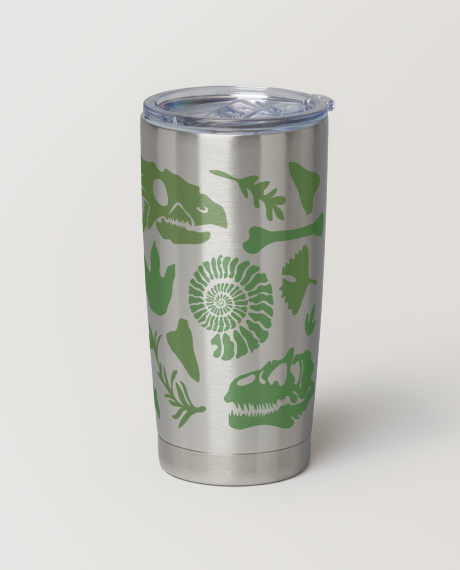 A silver stainless steel tumbler with a clear lid, decorated with green dinosaur and fossil-like designs.