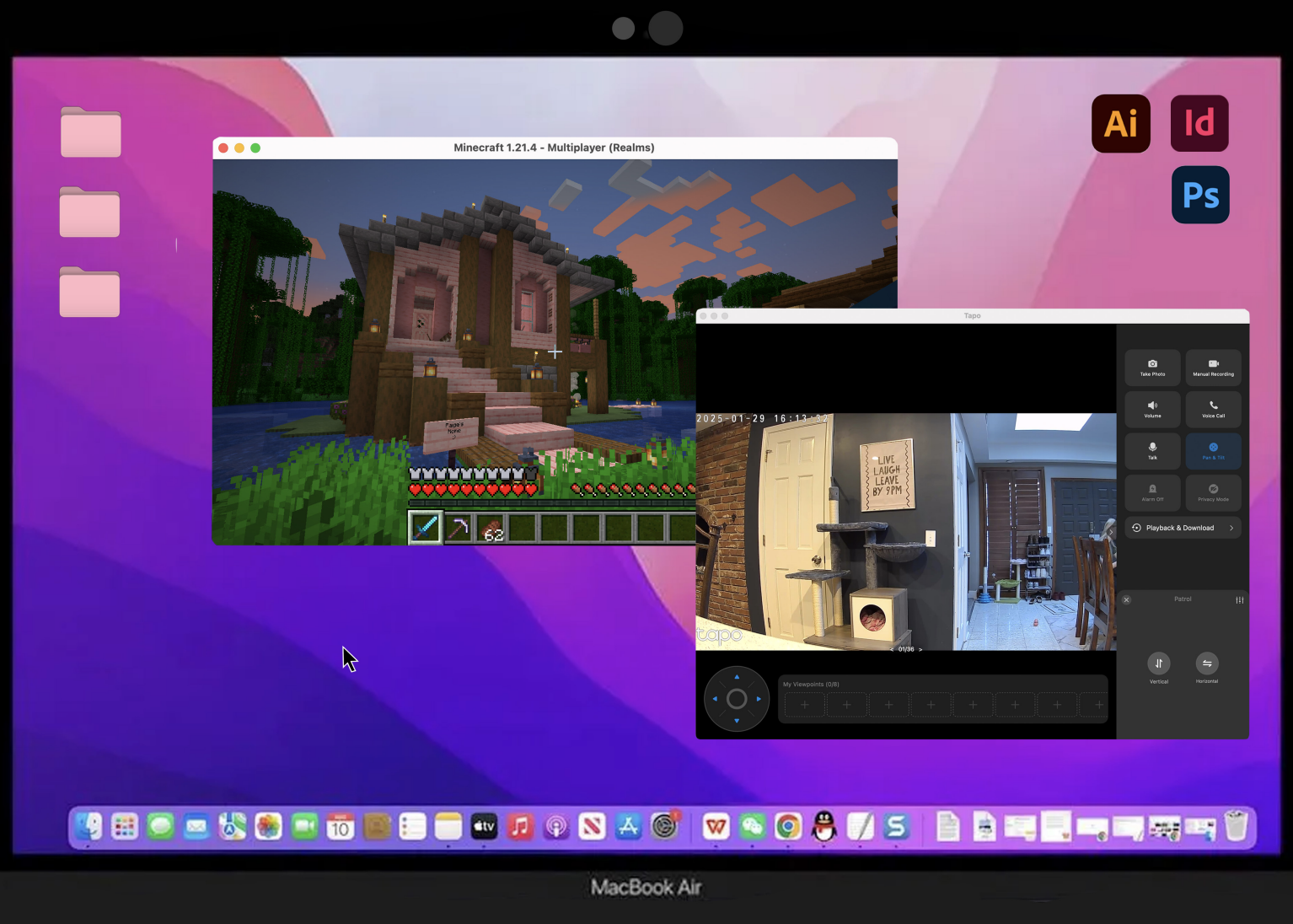 Screenshot of a MacBook Air desktop showing multiple open windows, including a Minecraft game with a house, a video call or security camera feed of a living room with a sign saying, "Live laugh leave by 9 PM," and software icons for Adobe Illustrator, InDesign, and Photoshop on the desktop background.