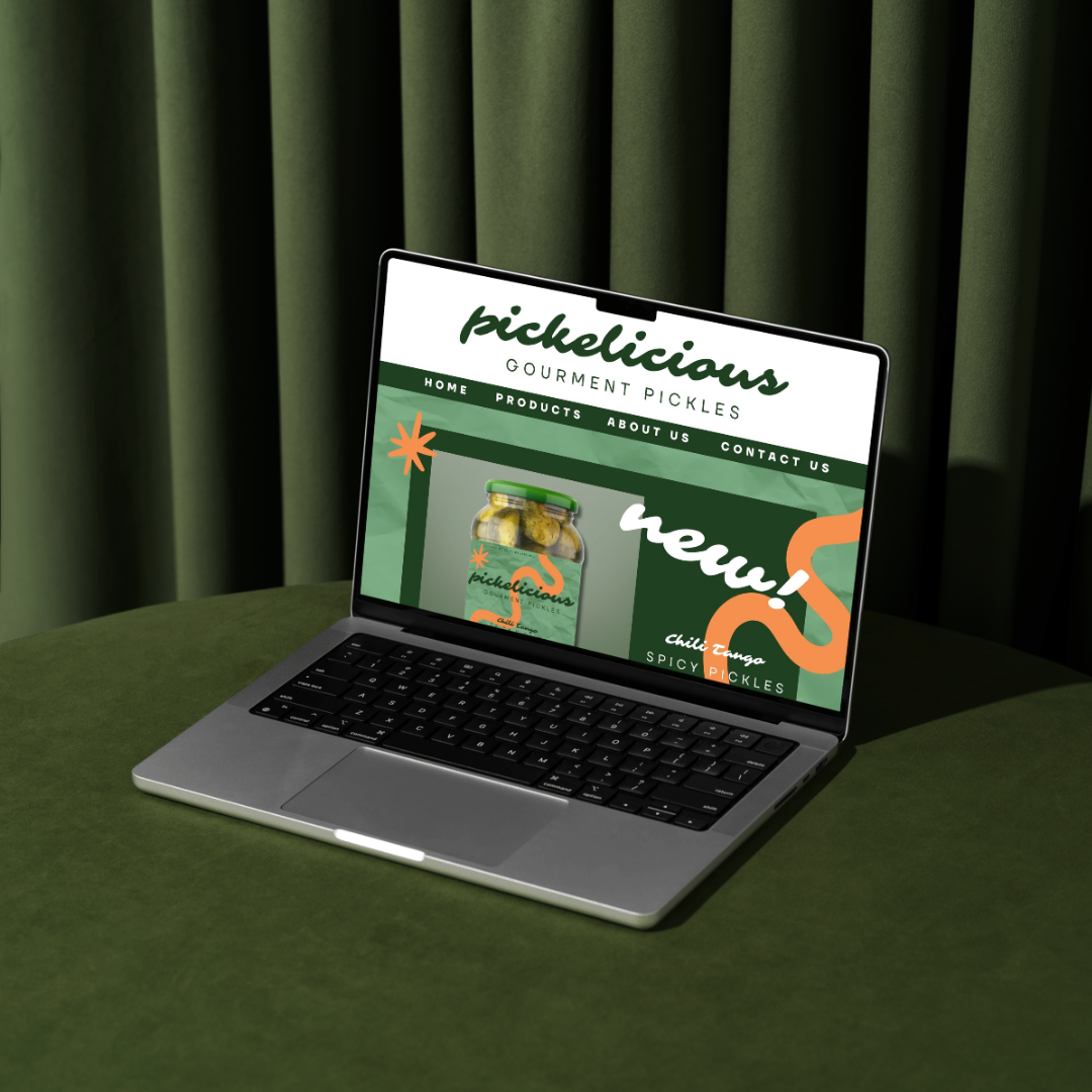 Laptop displaying the website for Picklicious gourmet pickles on a green table with green curtains in the background.