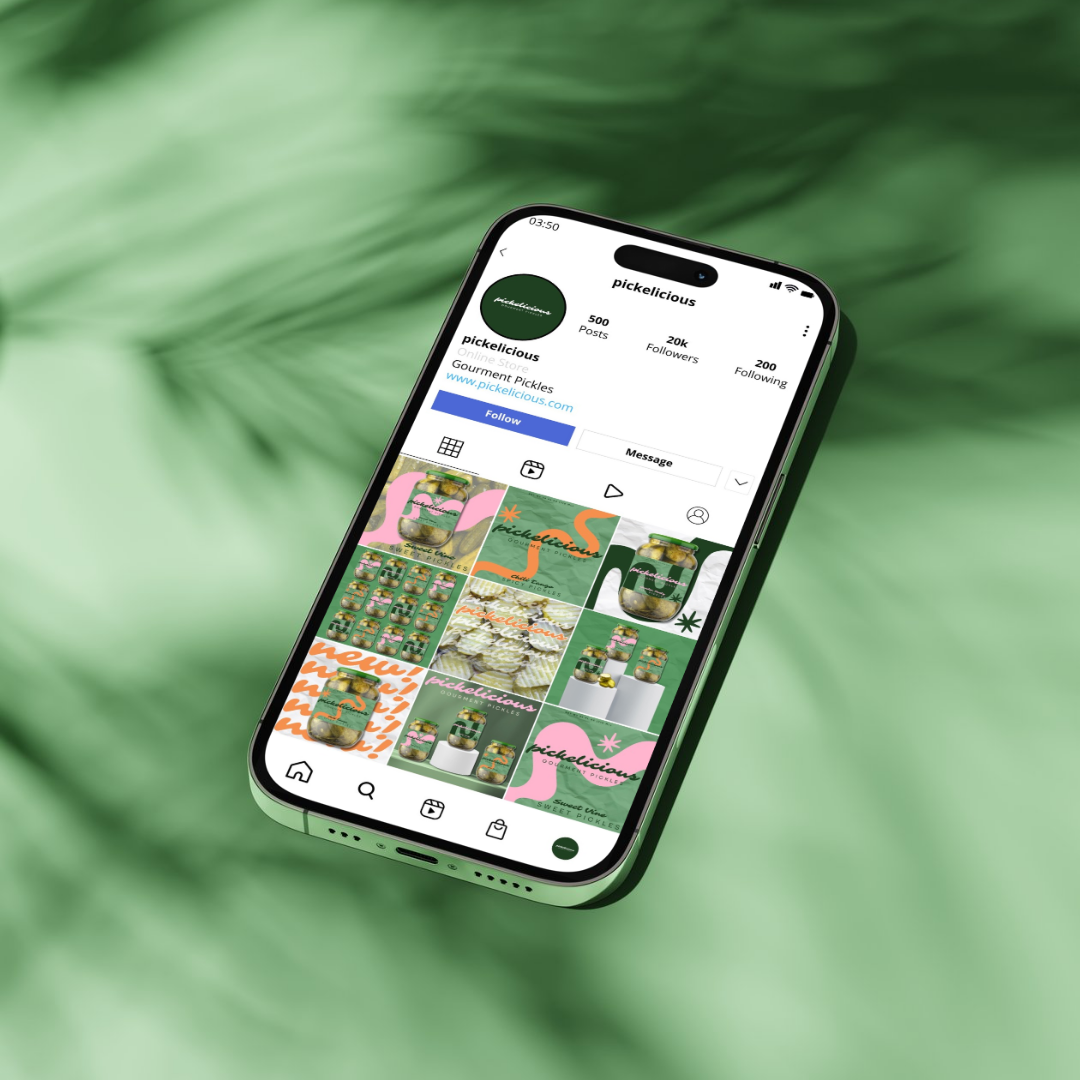 Smartphone displaying an Instagram profile called 'pickelicious' with various colorful pickle jar images, set against a blurred green leafy background.