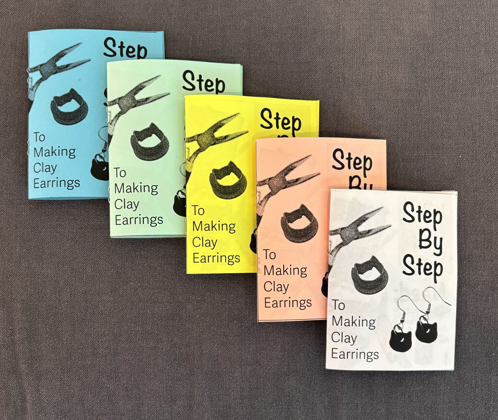 Colorful booklet covers arranged from left to right in blue, green, yellow, pink, and white, each featuring an illustration of pliers and the text 'Step By Step To Making Clay Earrings'.