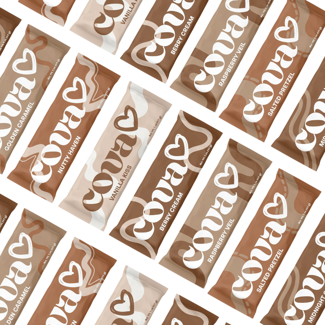 Multiple Cocomels caramel candy bars in various flavors such as vanilla kiss, salted pretzel, raspberry veil, berry cream, nutty haven, golden caramel, and midnight dark.