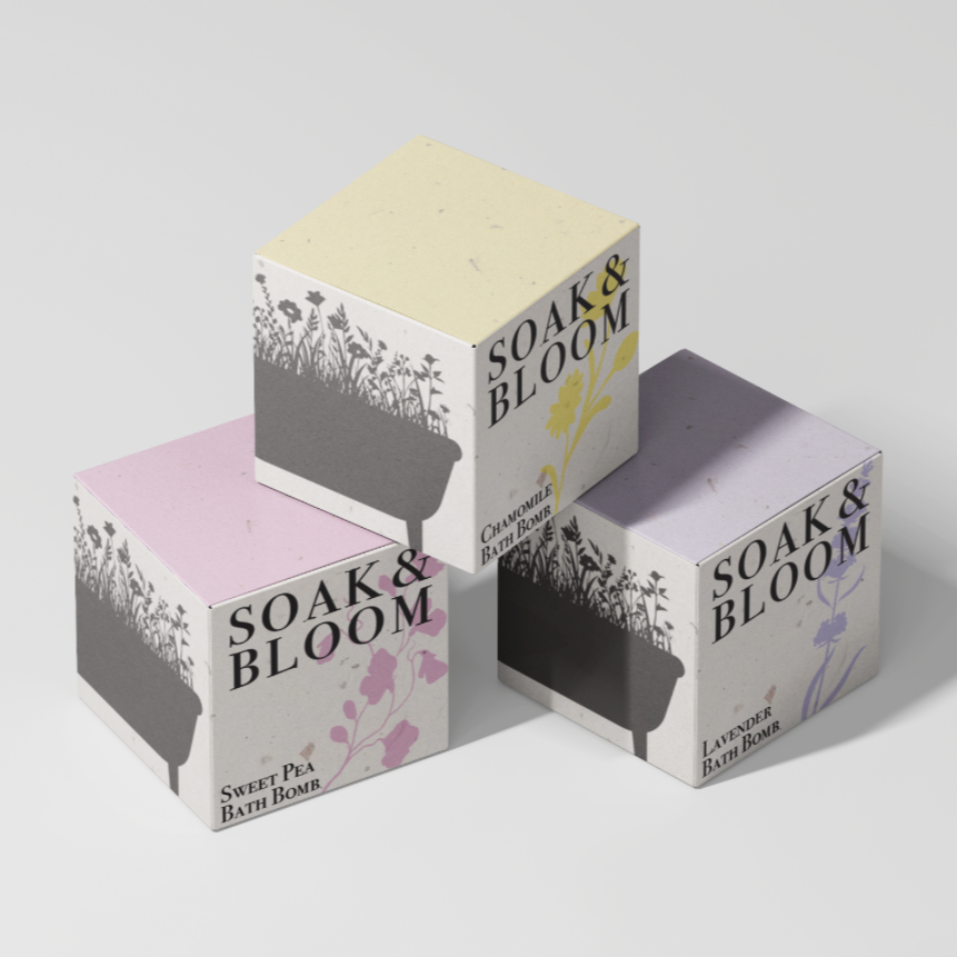 Three boxes of bath bombs labeled "Soak & Bloom" with different scents: Sweet Pea, Chamomile, and Lavender, each with floral illustrations.