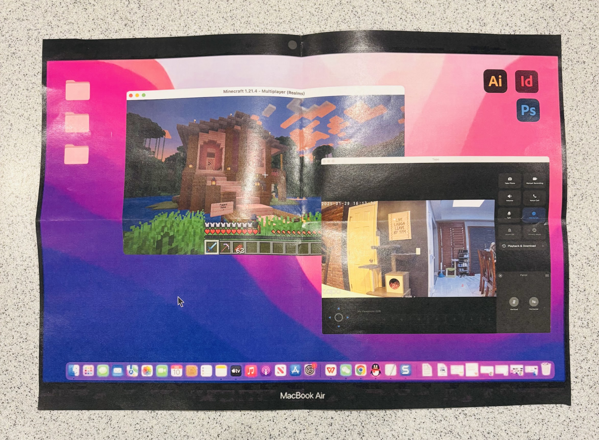 A MacBook Air screen displaying two open windows: one showing a Minecraft game with a large wooden house, and a second window showing a home interior with a yellow door and a sign that says "Live, Laugh, Leave By 8 PM." The background of the screen h