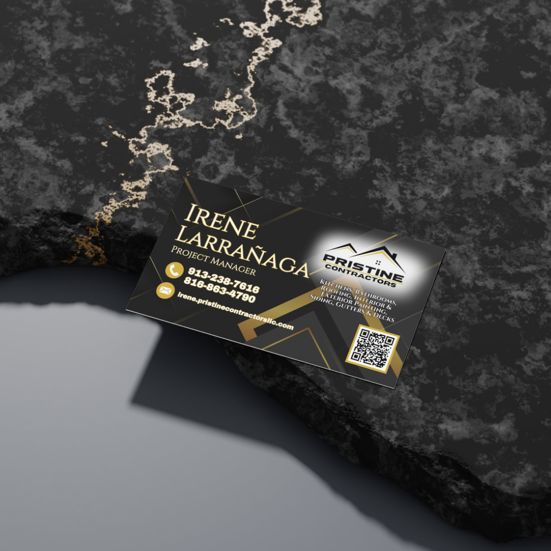 Business card for Irene Larránaga, project manager at Pristine Contractors, placed on a dark textured surface. The card features black, gold, and white colors, contact information, and a QR code.