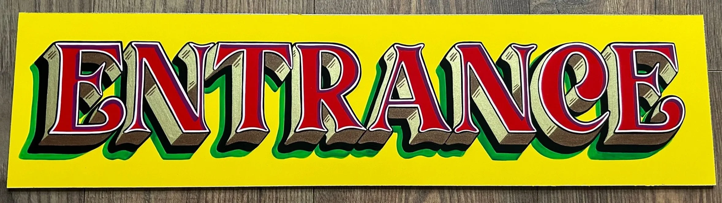 Colorful sticker with the word "ENTRANCE" in bold, 3D-style letters on a yellow background.