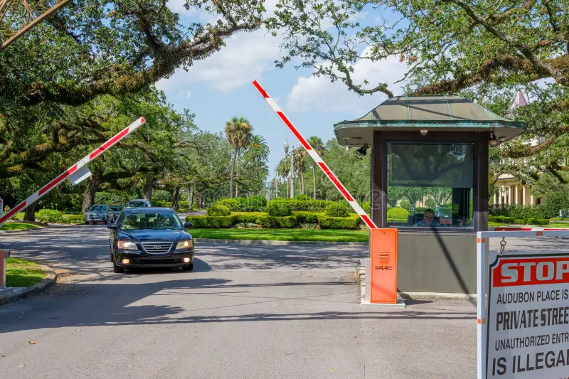 new-orleans-la-usa-july-open-gates-car-exiting-past-guard-shack-audubon-place-gated-community-st-charles-avenue-gated-327064759.png