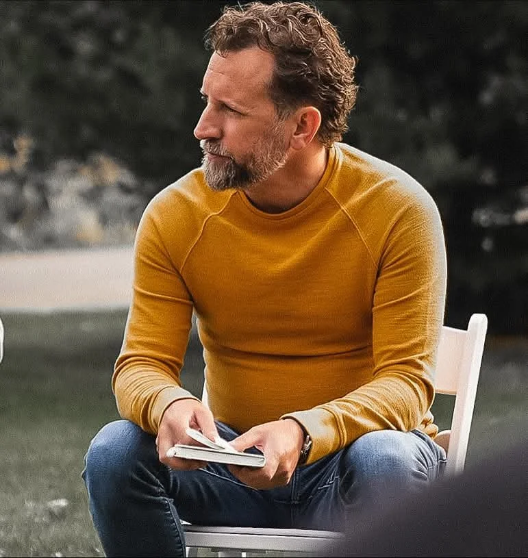 Man reading or writing outdoors, illustrating mental clarity, stress relief, and guided hypnosis for midlife adults.