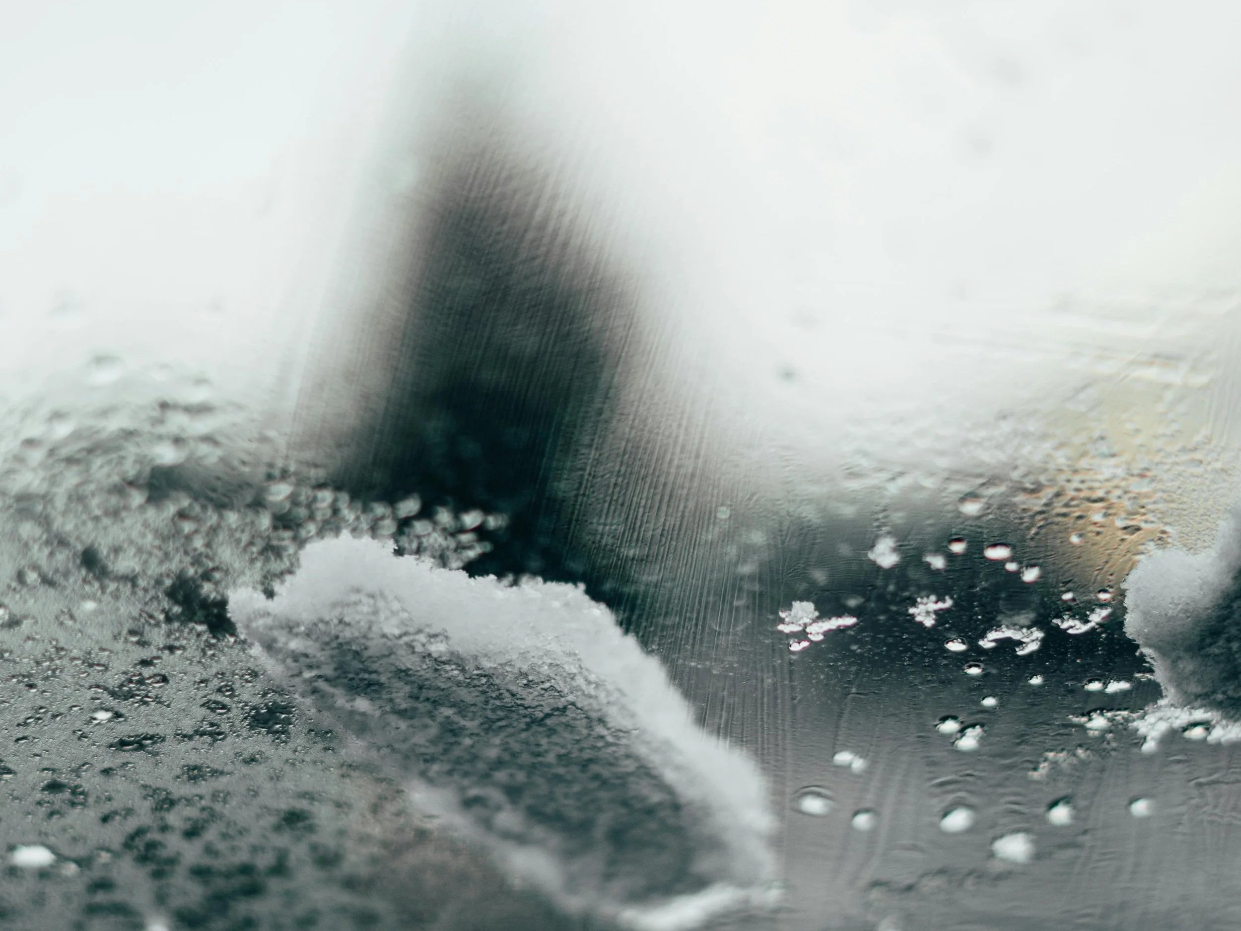 Frosted window pane with snow; figure in background symbolizing frozen nervous system