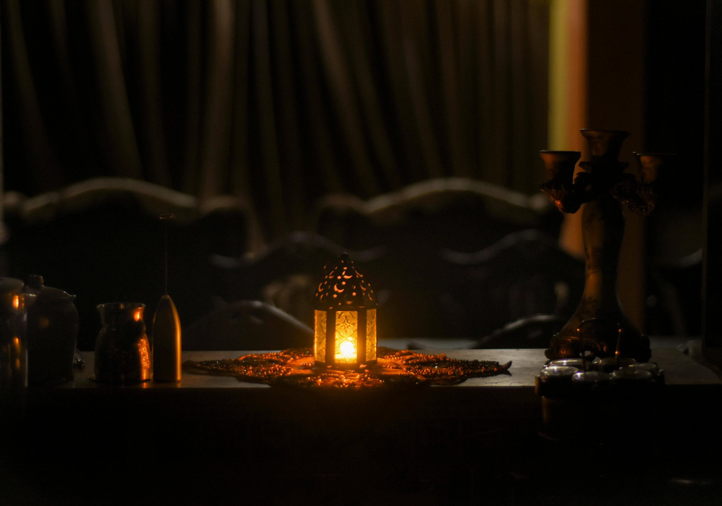 A candlelit winter interior with warm light and enclosed space, symbolizing nervous system regulation, safety, and embodied ritual.