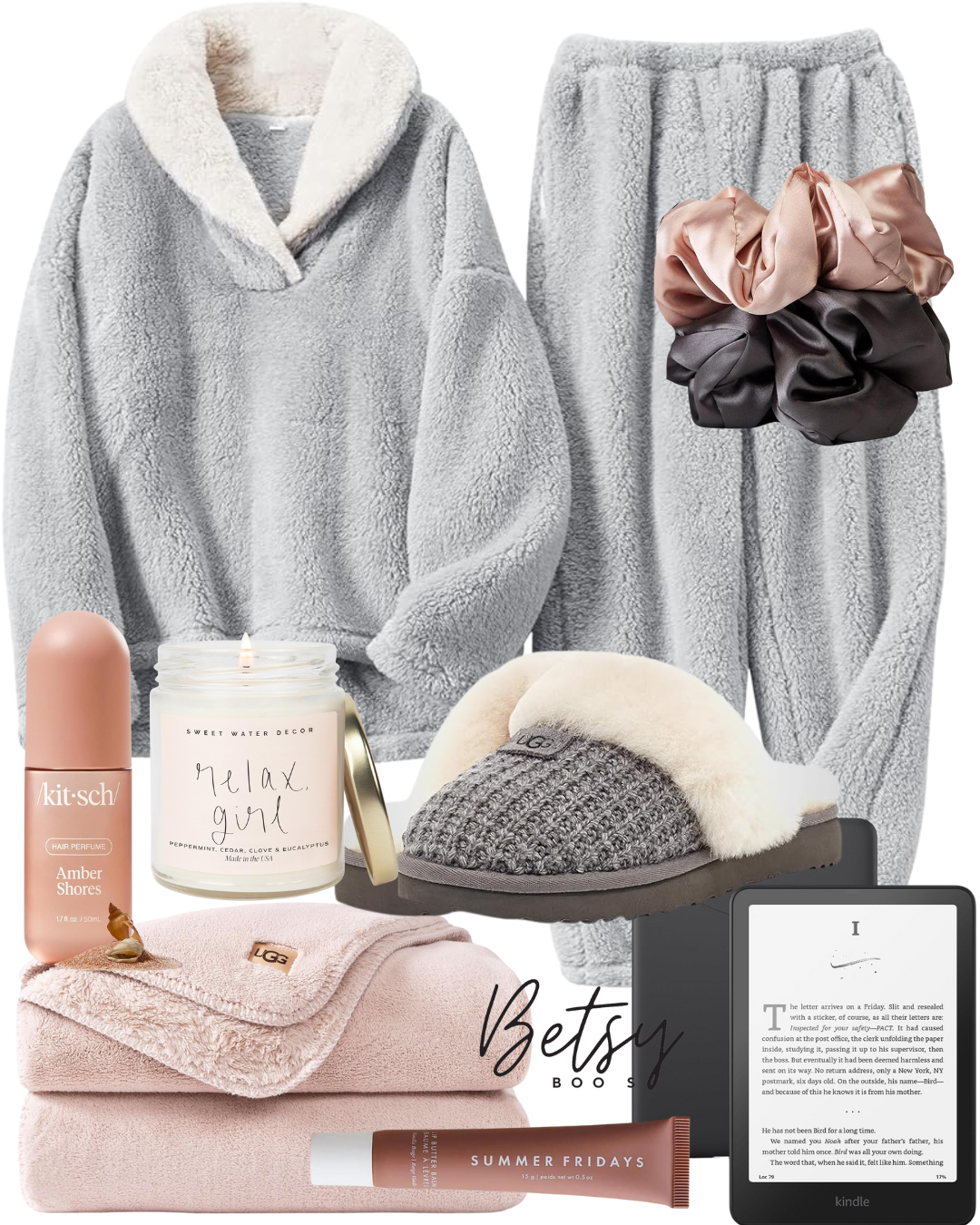 Cozy winter clothing and accessories including a gray fleece hoodie, gray fleece pants, fuzzy slippers, satin scrunchies, a candle, a hair perfume, a blanket, a pink tube of lotion, and an e-reader.
