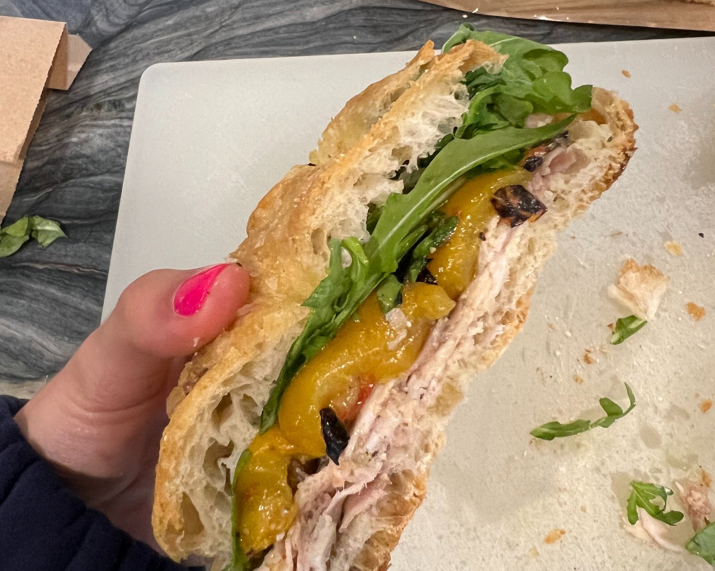 schiacciata bread, porchetta, roasted peppers, arugula