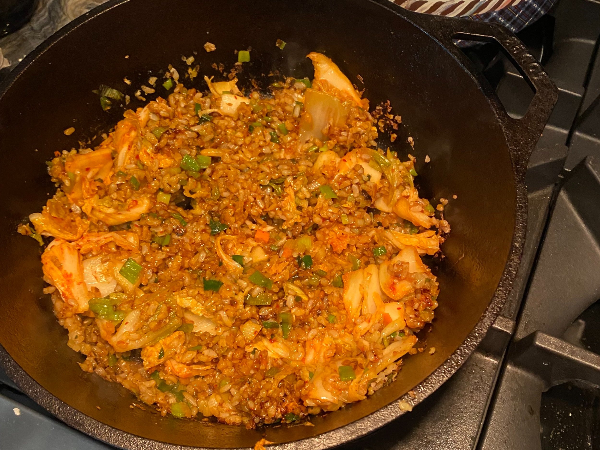 fried cauliflower rice with kimchi, scallions, and an egg