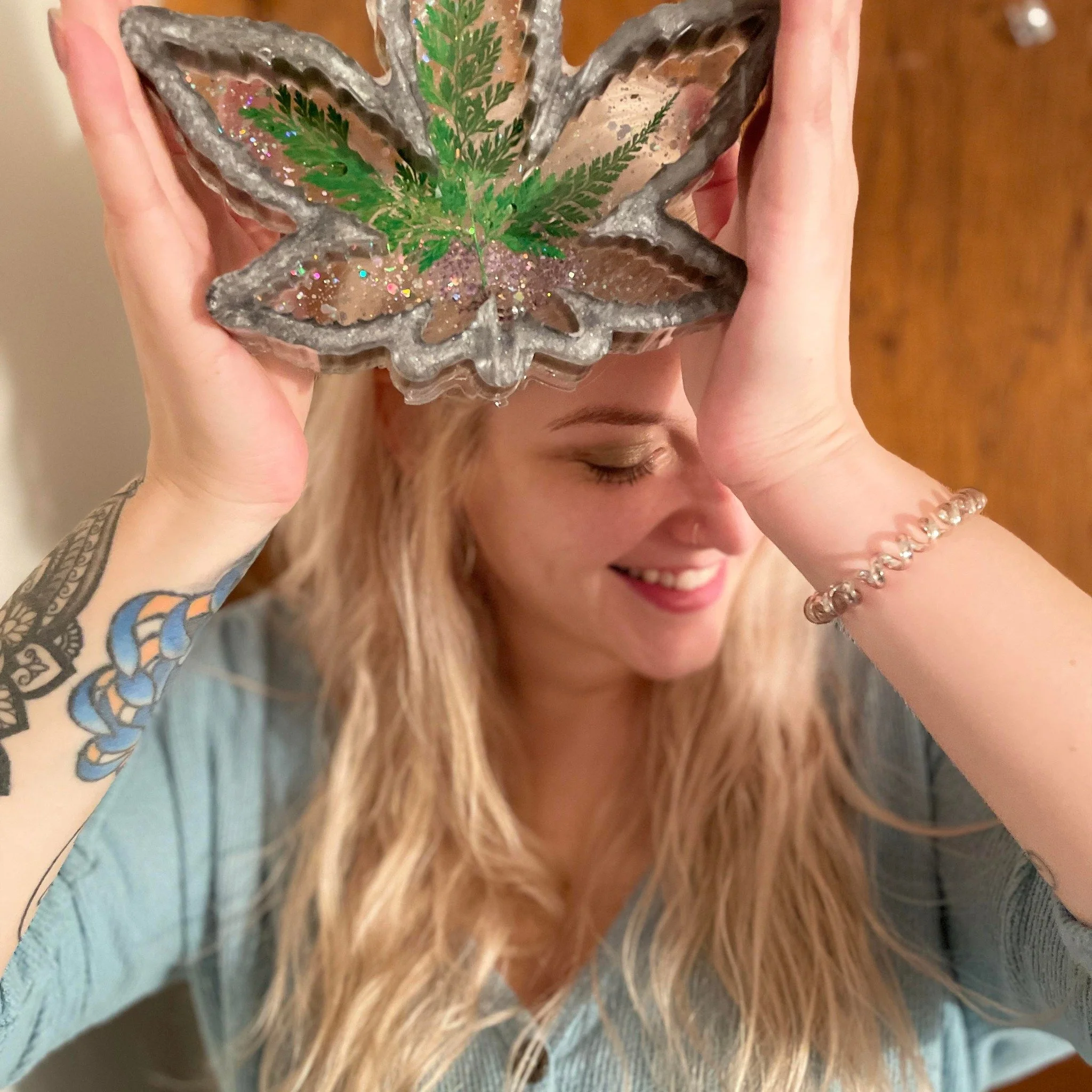 Tori, owner of TorzRezin in WNY, holding a custom resin creation