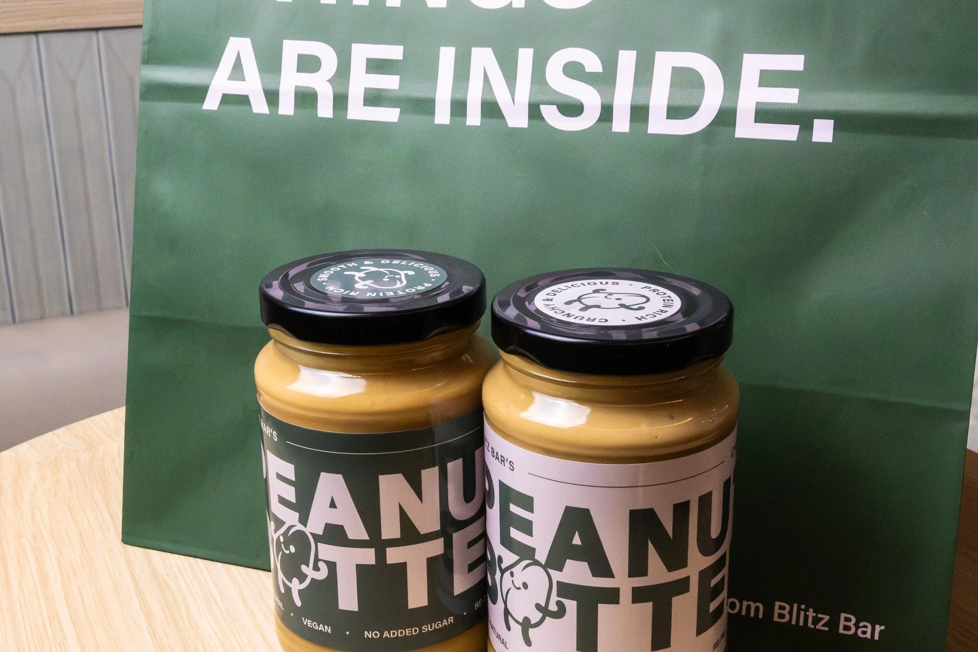 Blitz Bar smooth and crunchy peanut butter jars with a Blitz Bar takeaway bag