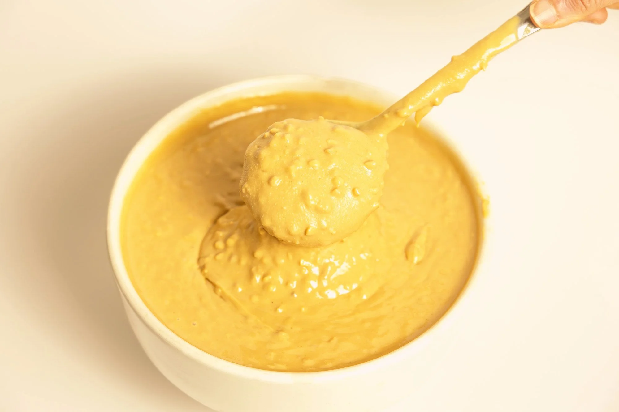 Crunchy peanut butter in a bowl showing the peanut pieces