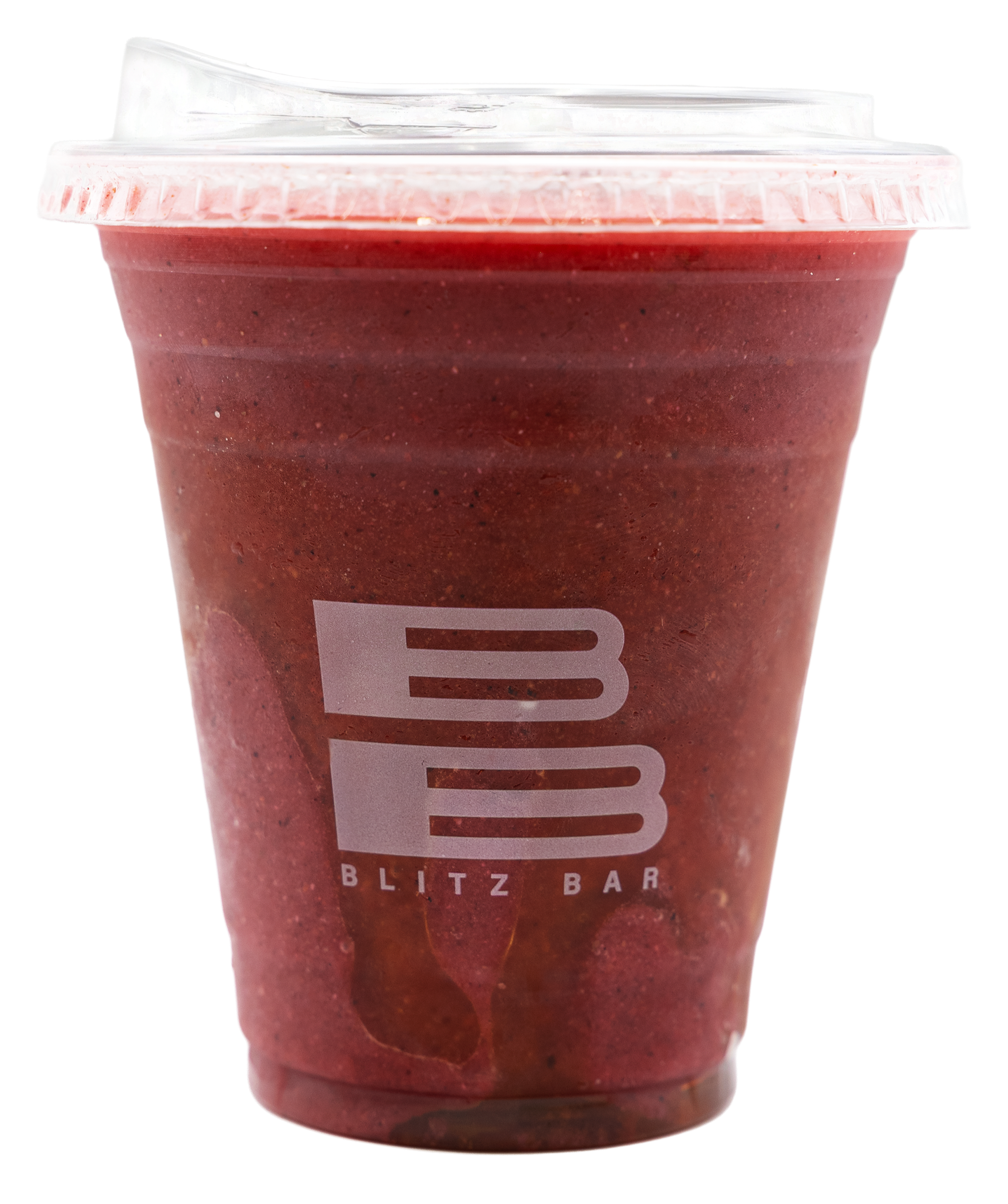 A pink, blended smoothie in a clear plastic cup with a dome lid and a white straw.
