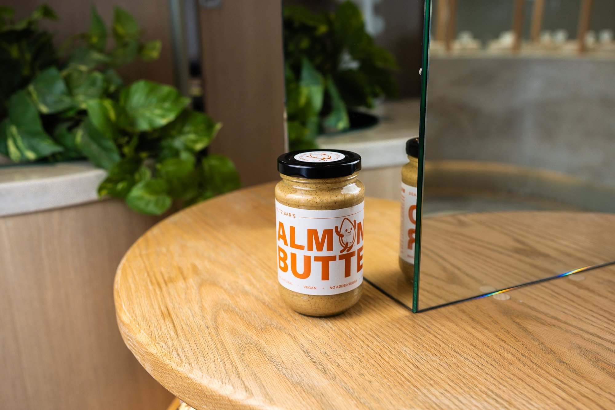 Jar of Blitz Bar almond butter on a table inside a Blitz Bar store in Melbourne