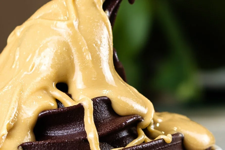 Blitz Bar peanut butter poured over a chocolate acai bowl