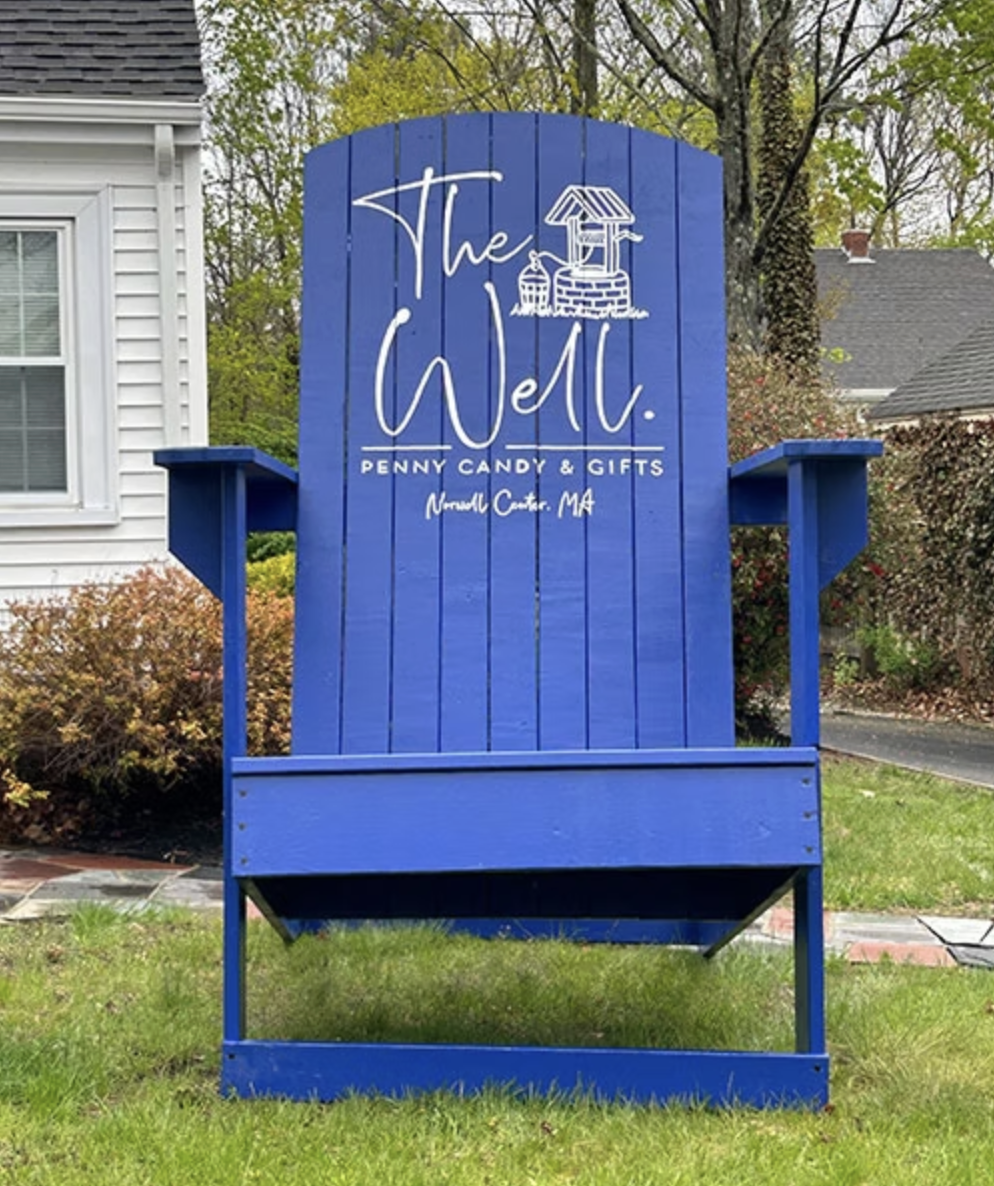 Giant blue Adirondack chair in front of The Well in Norwell Center