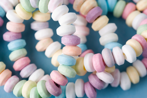 Colorful pastel candy beads on a blue background.