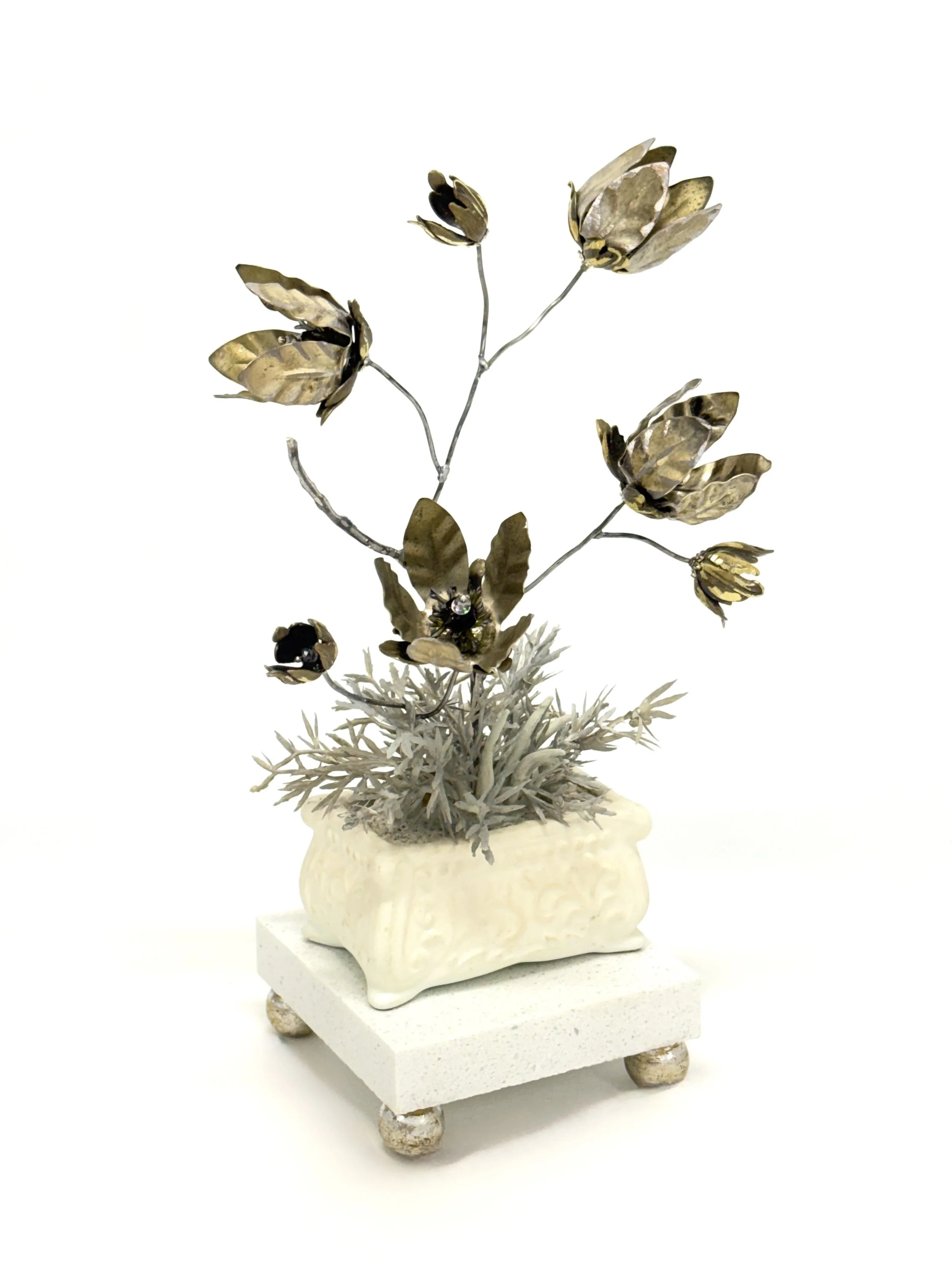 'What you Seek is Seeking you' Found and ready-made objects, air-dry clay, artificial foliage in cement in vintage dish on composite wood stone and wood base. H 28cm x W 23cm x D 15cm. 2026