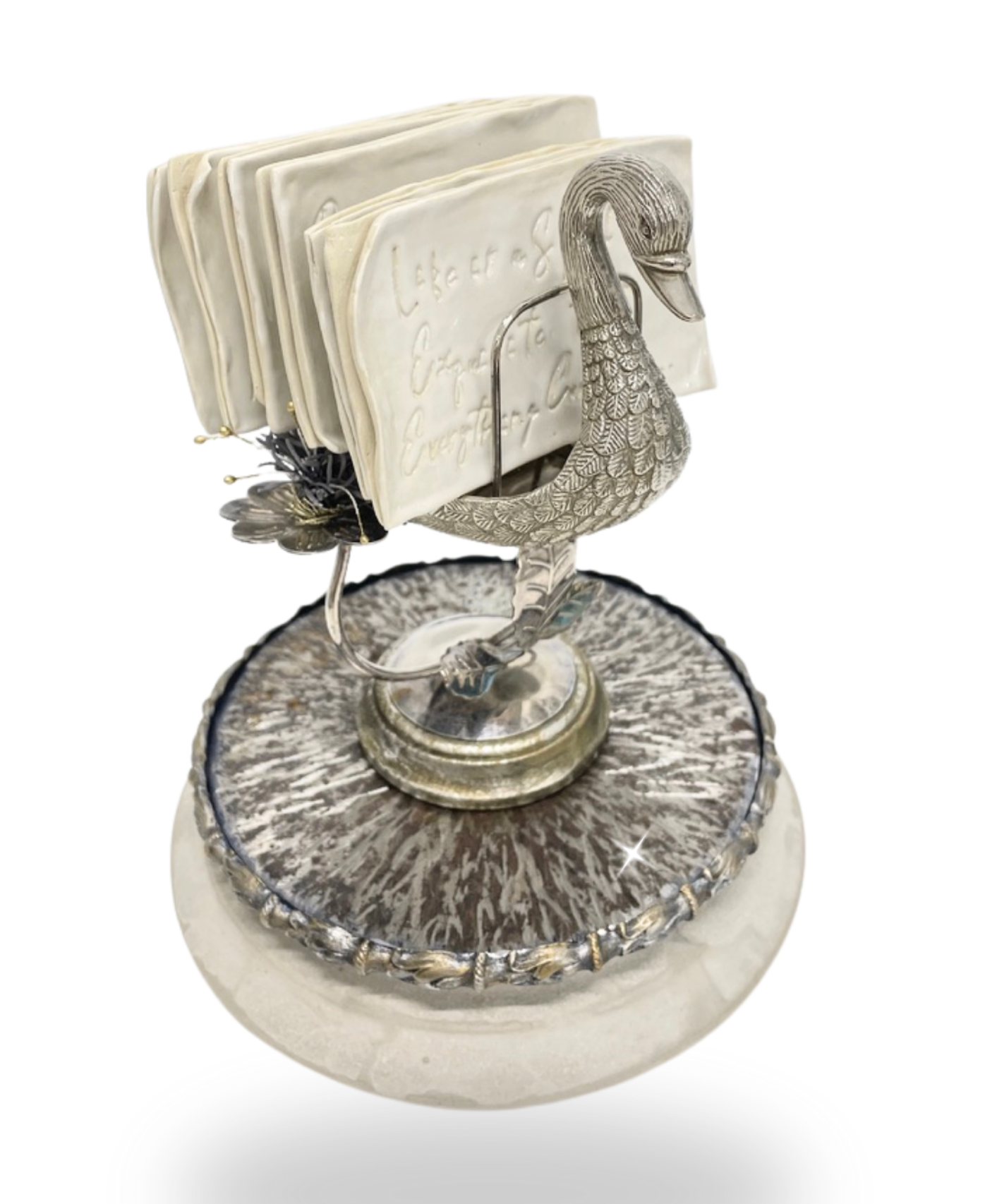 'Life is a Spell so Exquisite that Everything Conspires to Break it' - Emily Dickenson. Glazed stoneware, engraved steel, vintage metal swan object, artificial foliage, painted composite wood on cement base. H 24cm x W 20cm x D 20cm. 2026