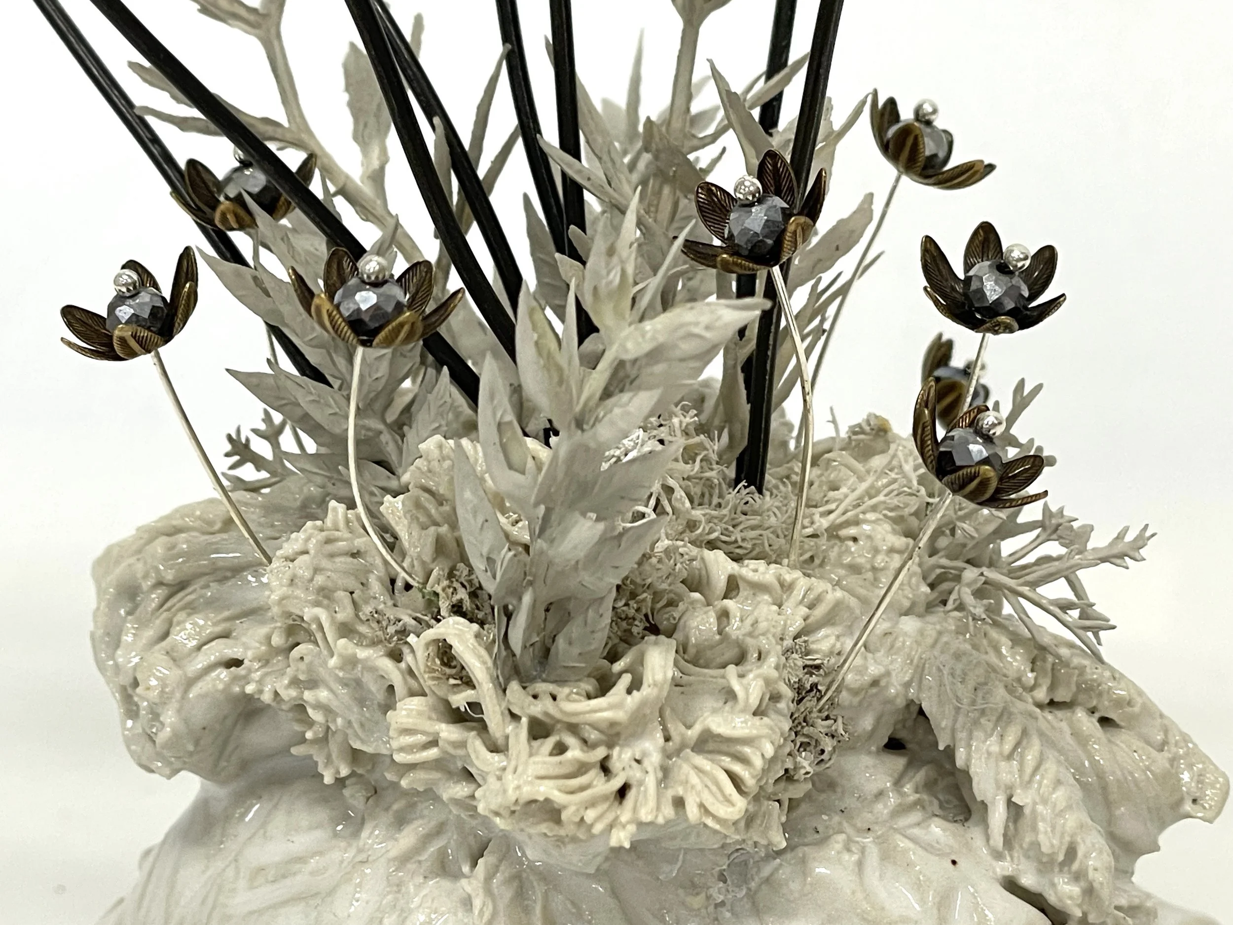 Detail: Glazed stoneware, artificial leaves, acrylic paint, metal bead-caps, steel, sequins and beads on marble.