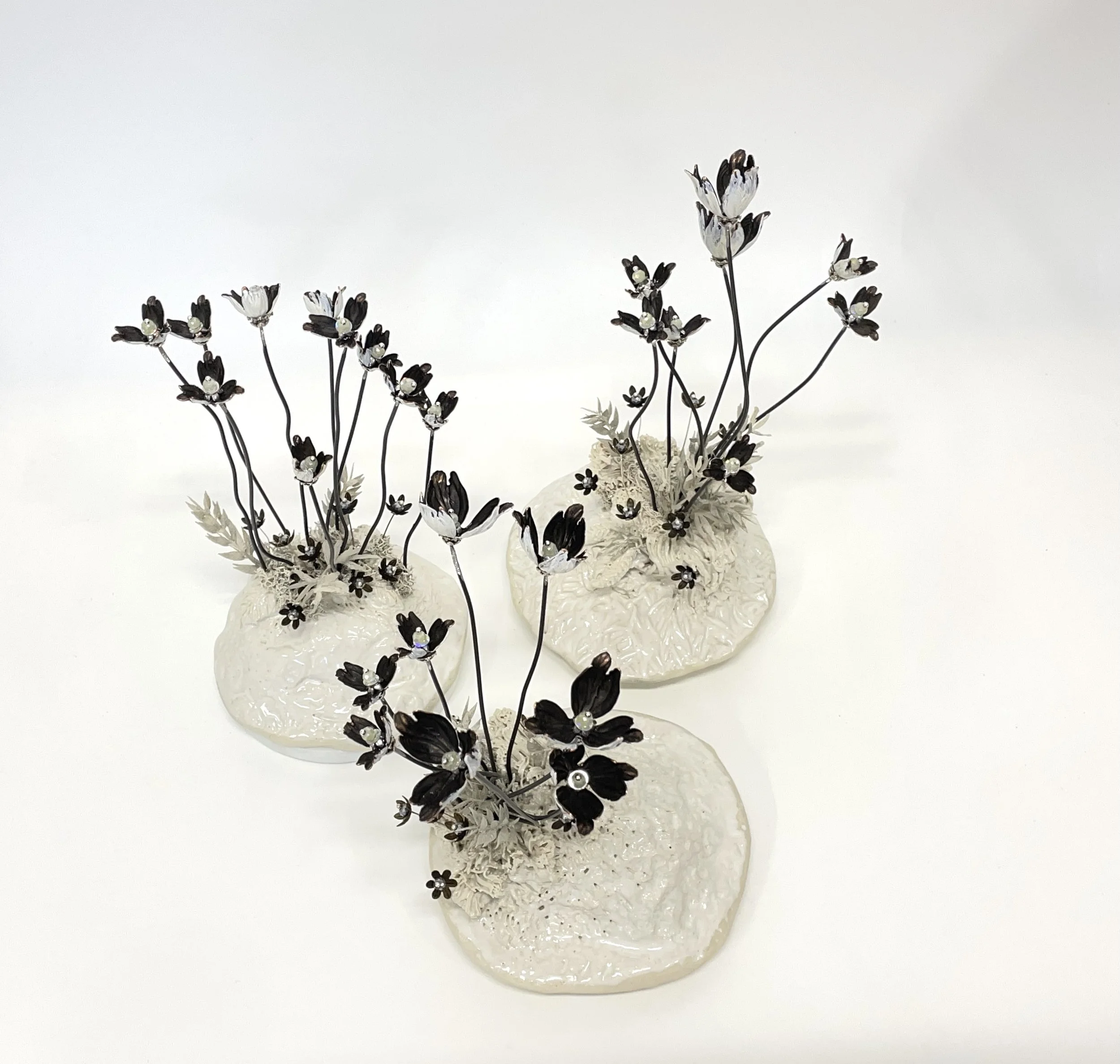 Glazed stoneware, artificial leaves, acrylic paint, metal bead-caps, steel, sequins and beads on marble.