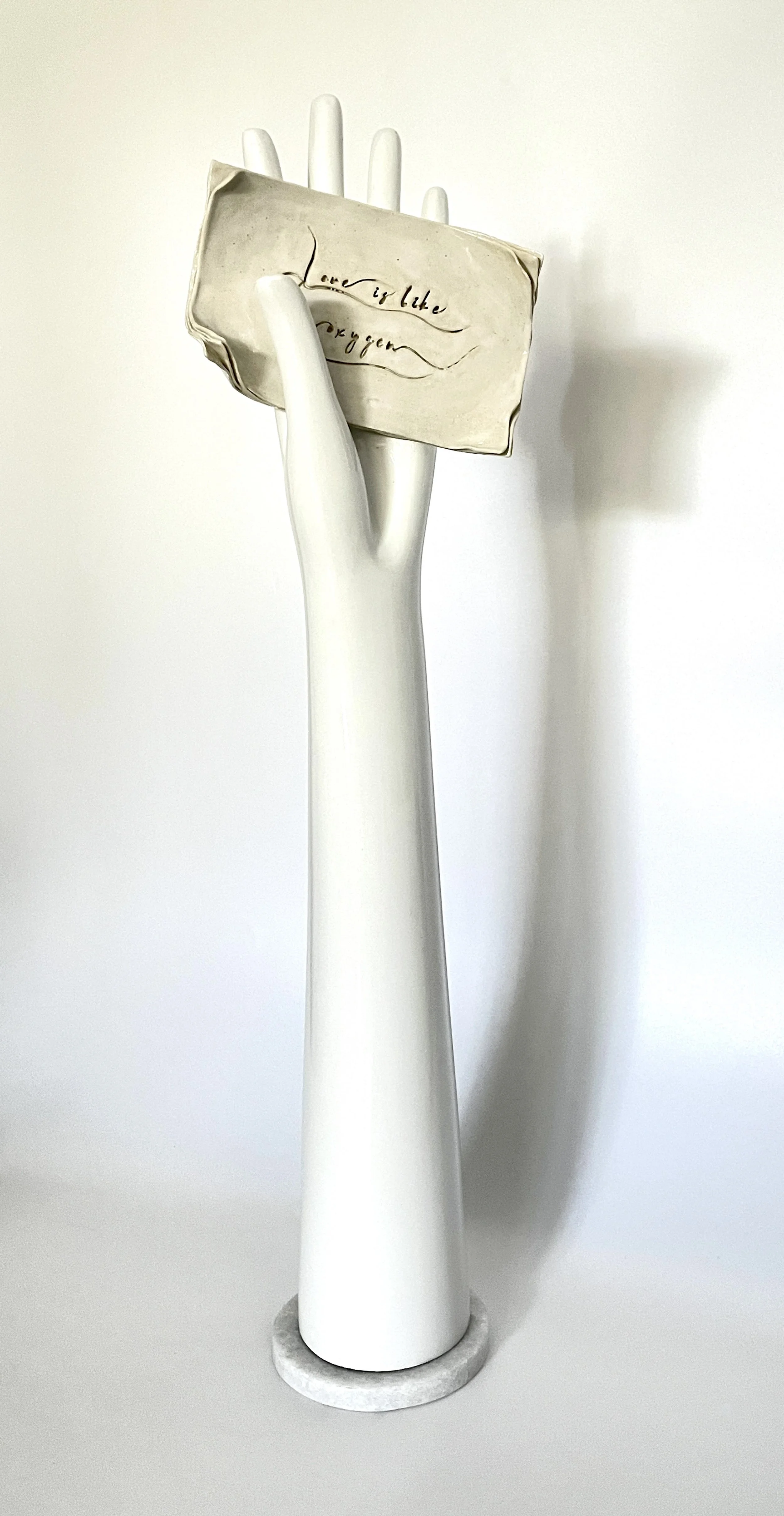 'Love is like oxygen' Glazed stoneware and ready-made/found hand object.