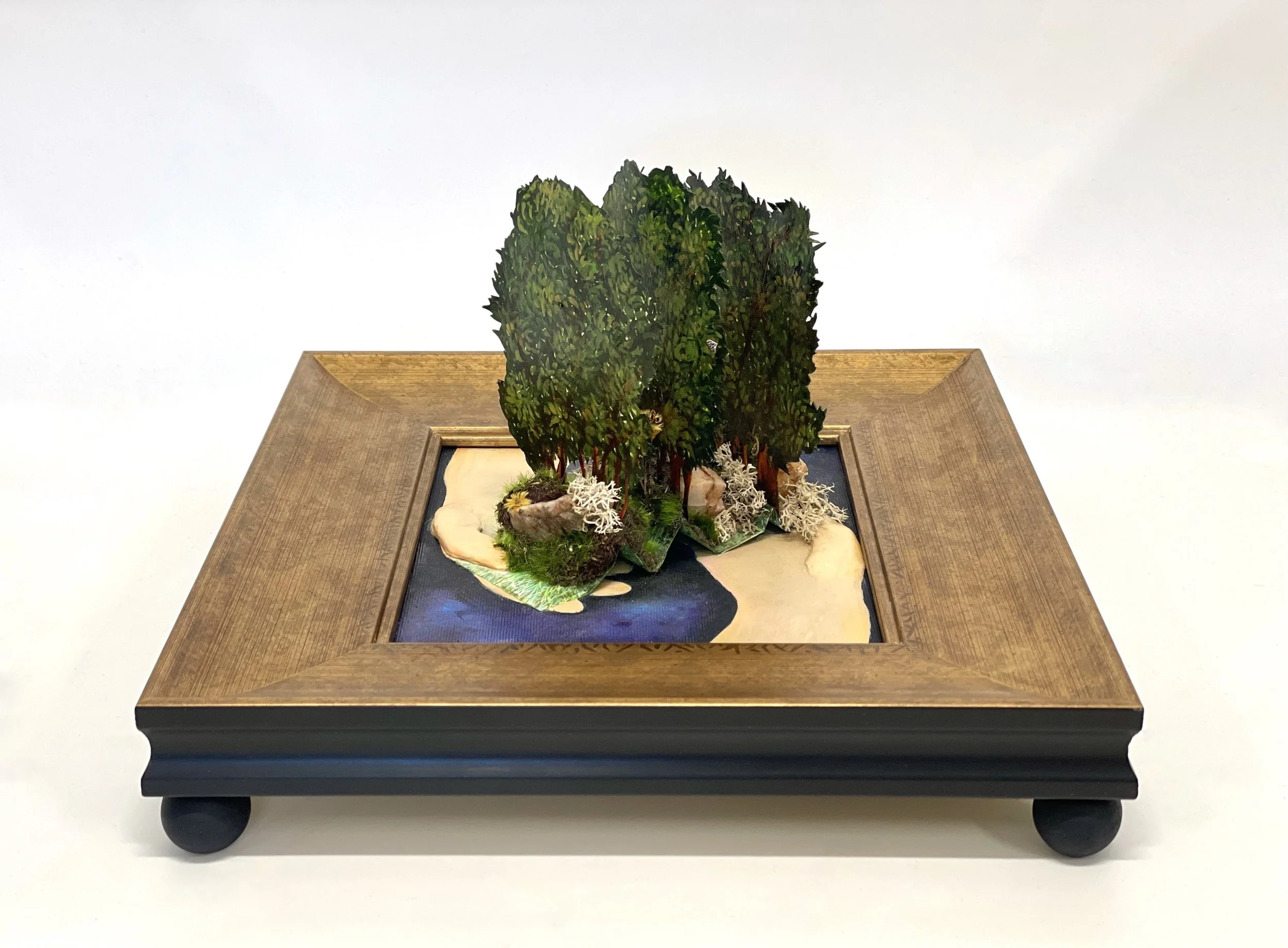Paper, acrylic paint, air-dry clay, natural rock and moss on artist panel in custom framed base.