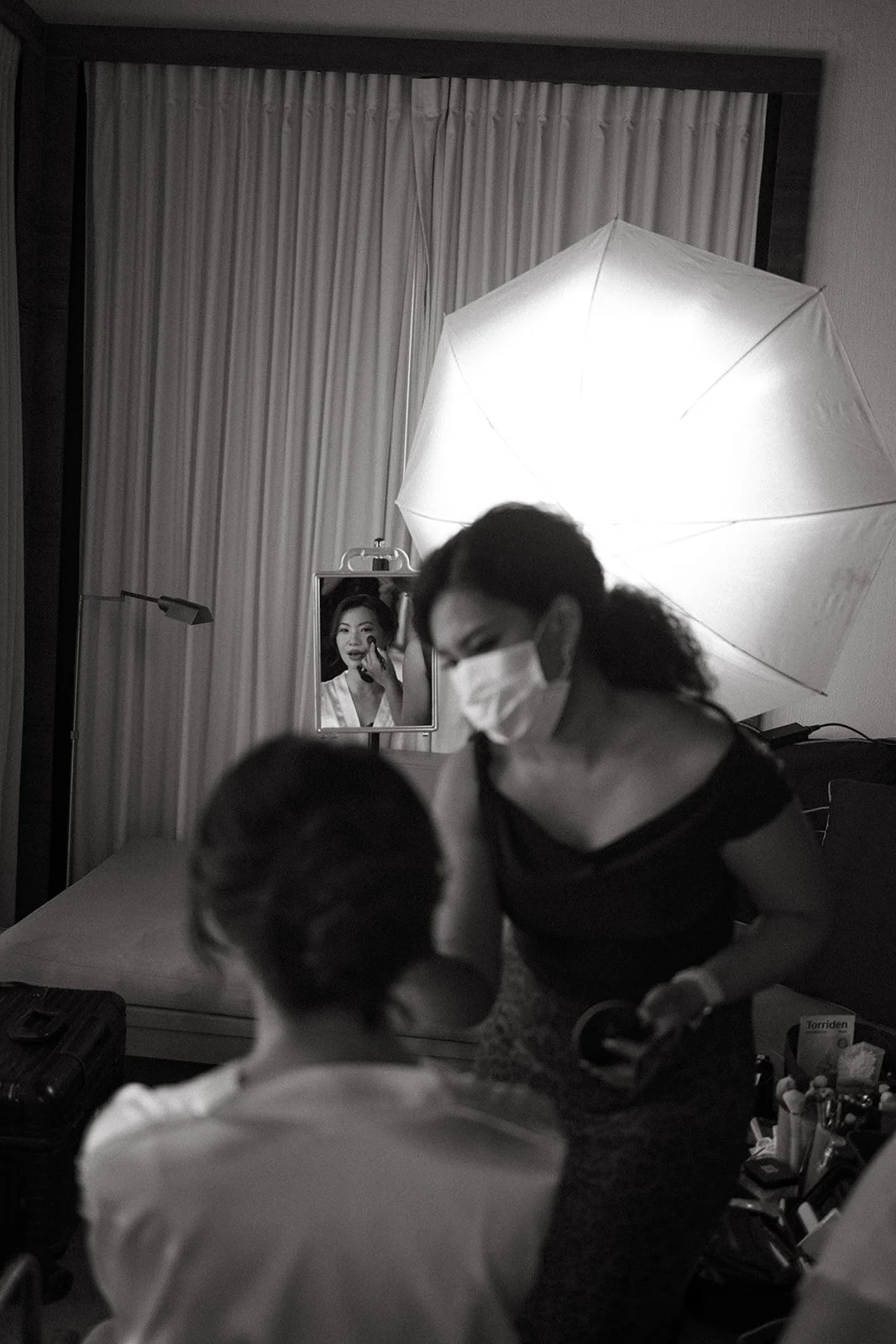 Makeup artist applying finishing touches to the bride at Sri Panwa resort