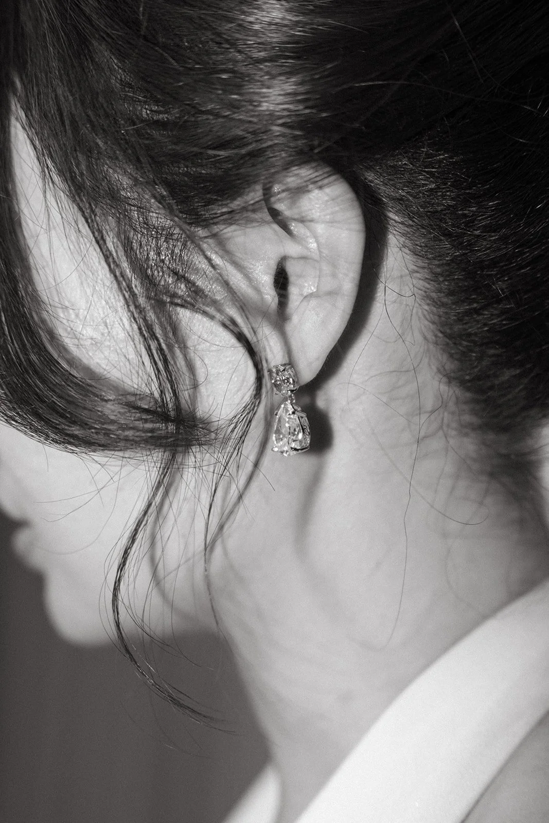 close up portrait of bride's diamond wedding earrings