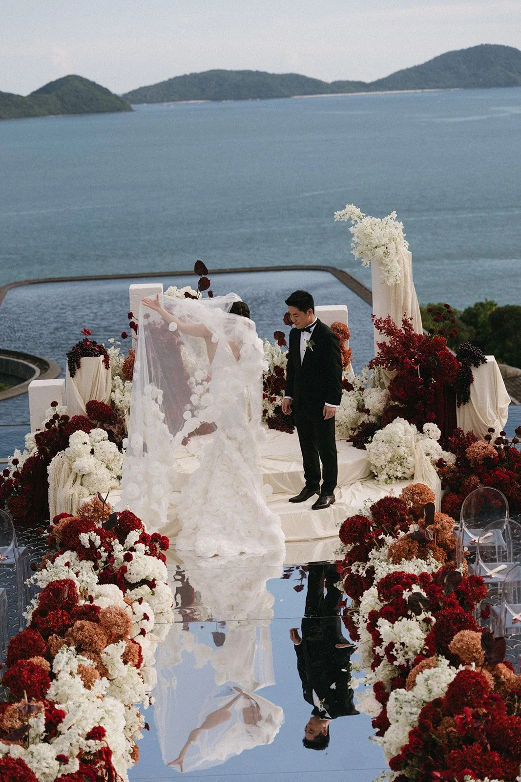 Red and white modern Asian wedding ceremony flowers with grapes, amaranthus, and hydrangeas at a Phuket destination wedding