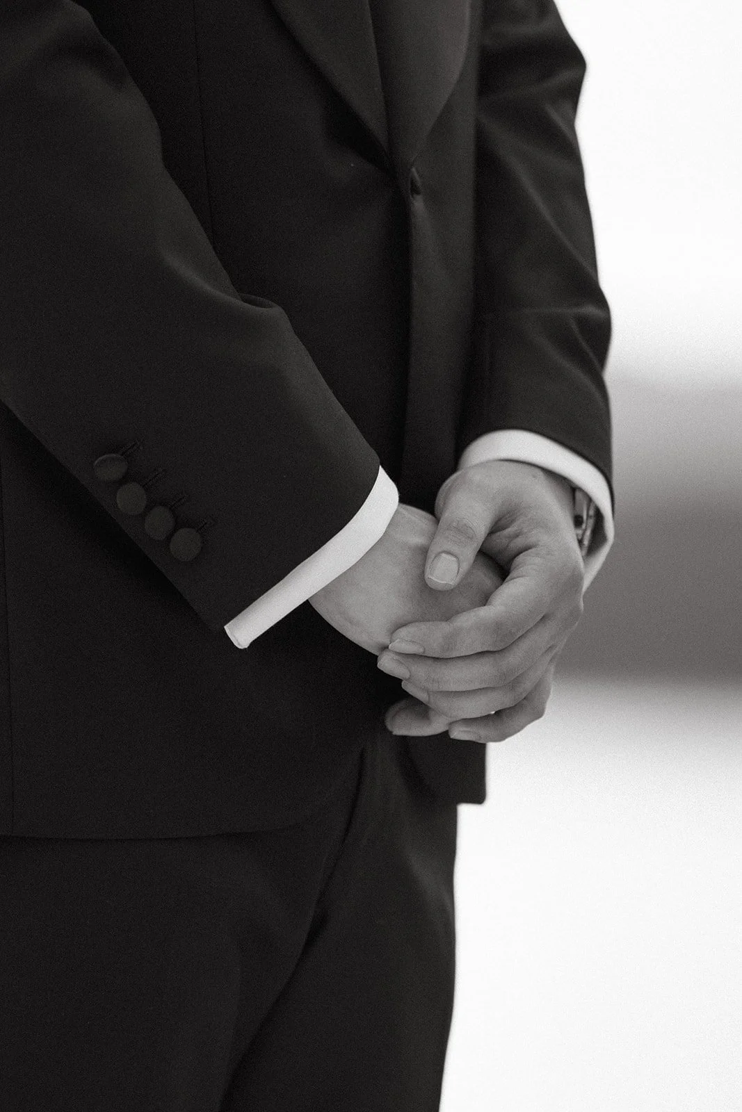 close up of grooms hands as bride walks down the aisle at sri panwa