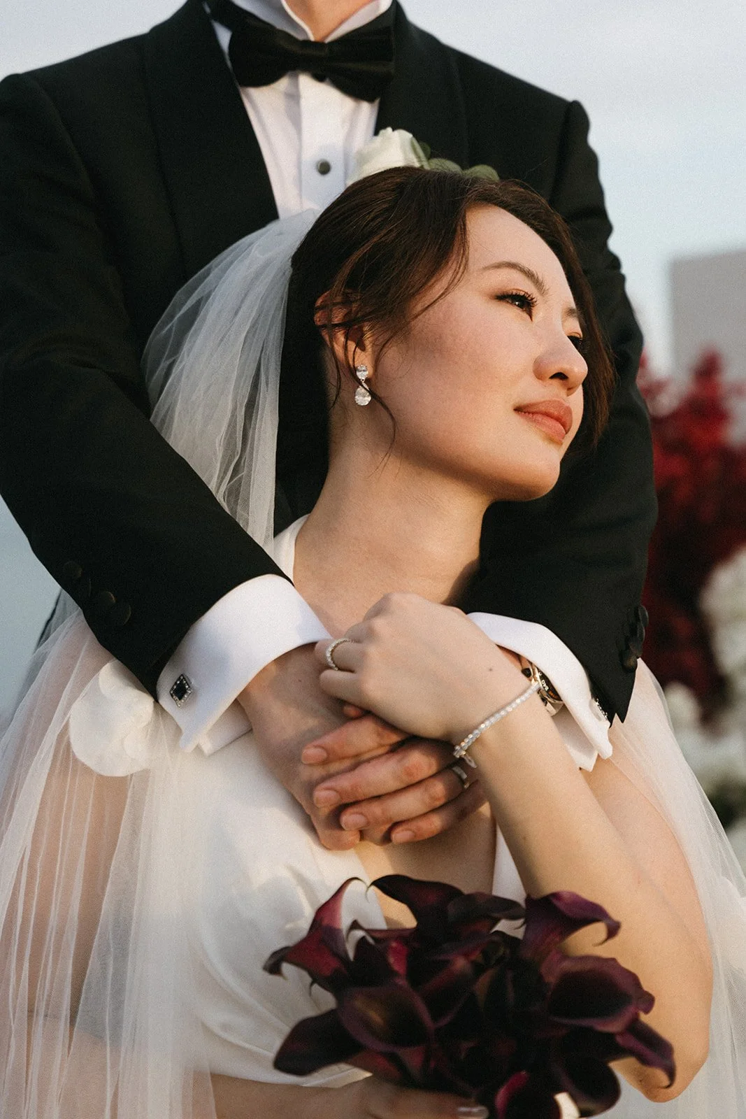 Groom embracing bride during intimate ceremony at luxury destination wedding in Phuket, Thailand