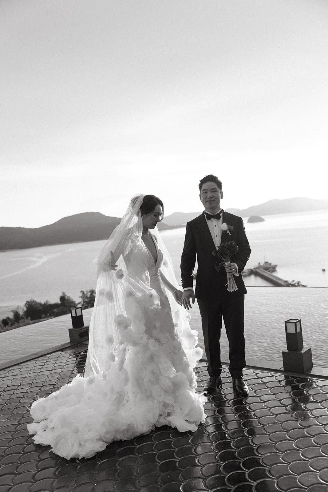 Black and white photo of bride and groom walking together post-ceremony at Sri Panwa Phuket